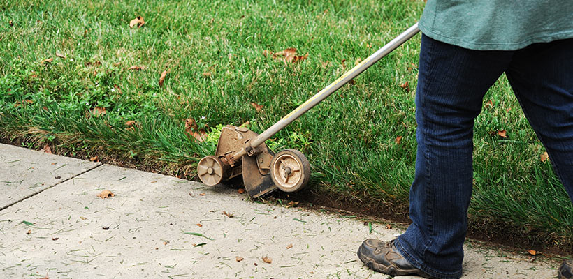 Use a manual or powered lawn edger to cut a vertical edge.