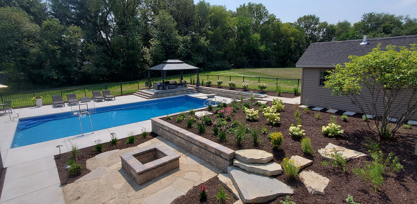 Leveling Up Your Sloped Backyard with an In-Ground Pool Patio