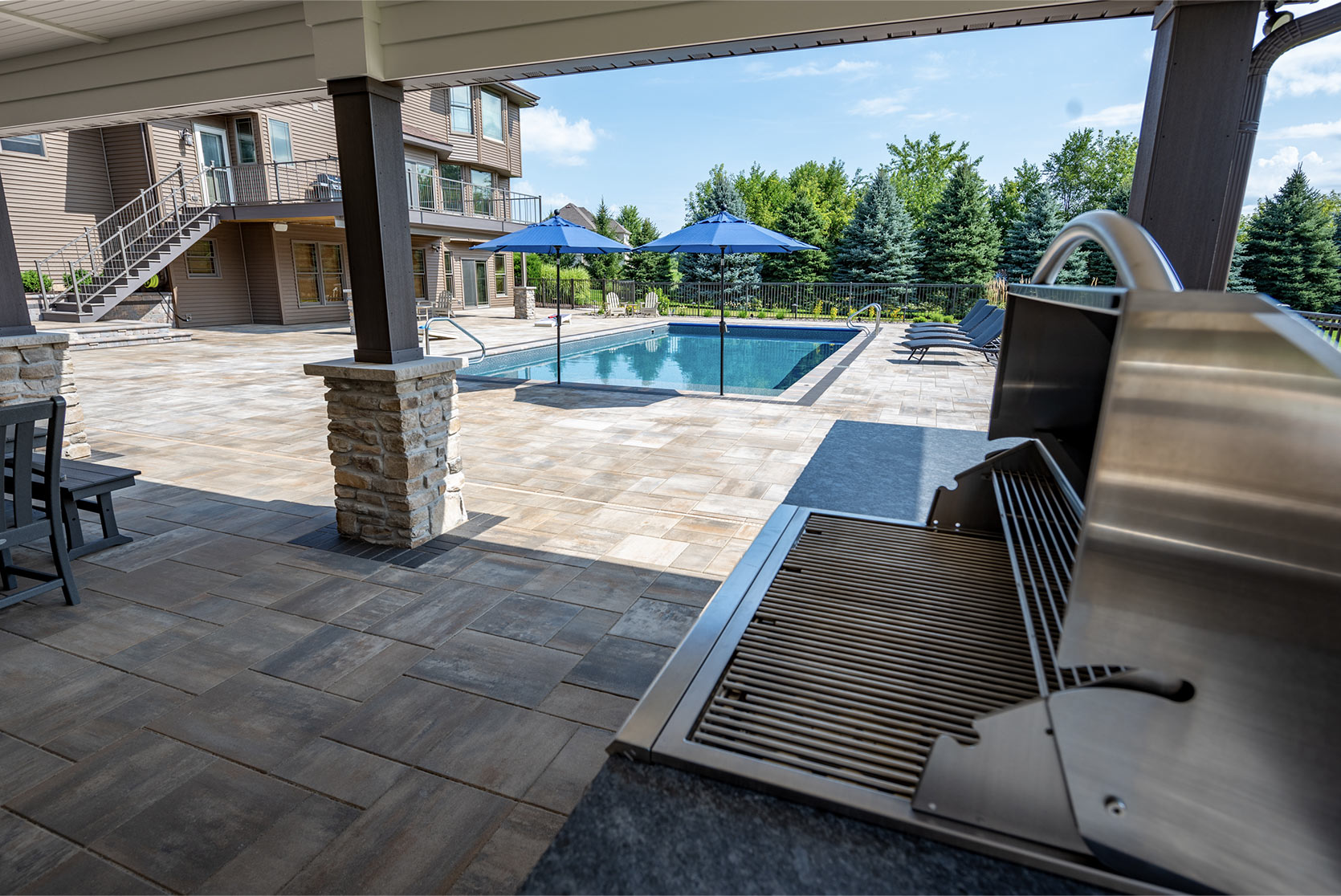 Achieving unity with a kitchen, pool, and firepit
